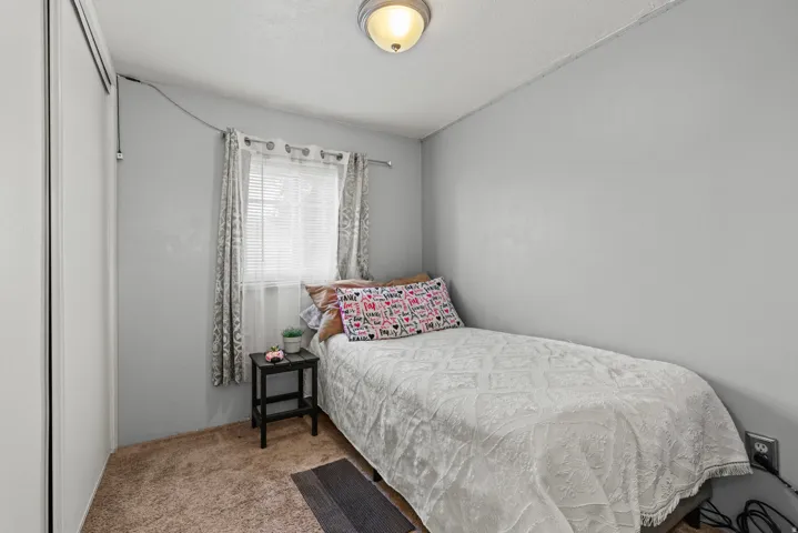 Room with light gray walls, textured ceiling, and brown carpet flooring