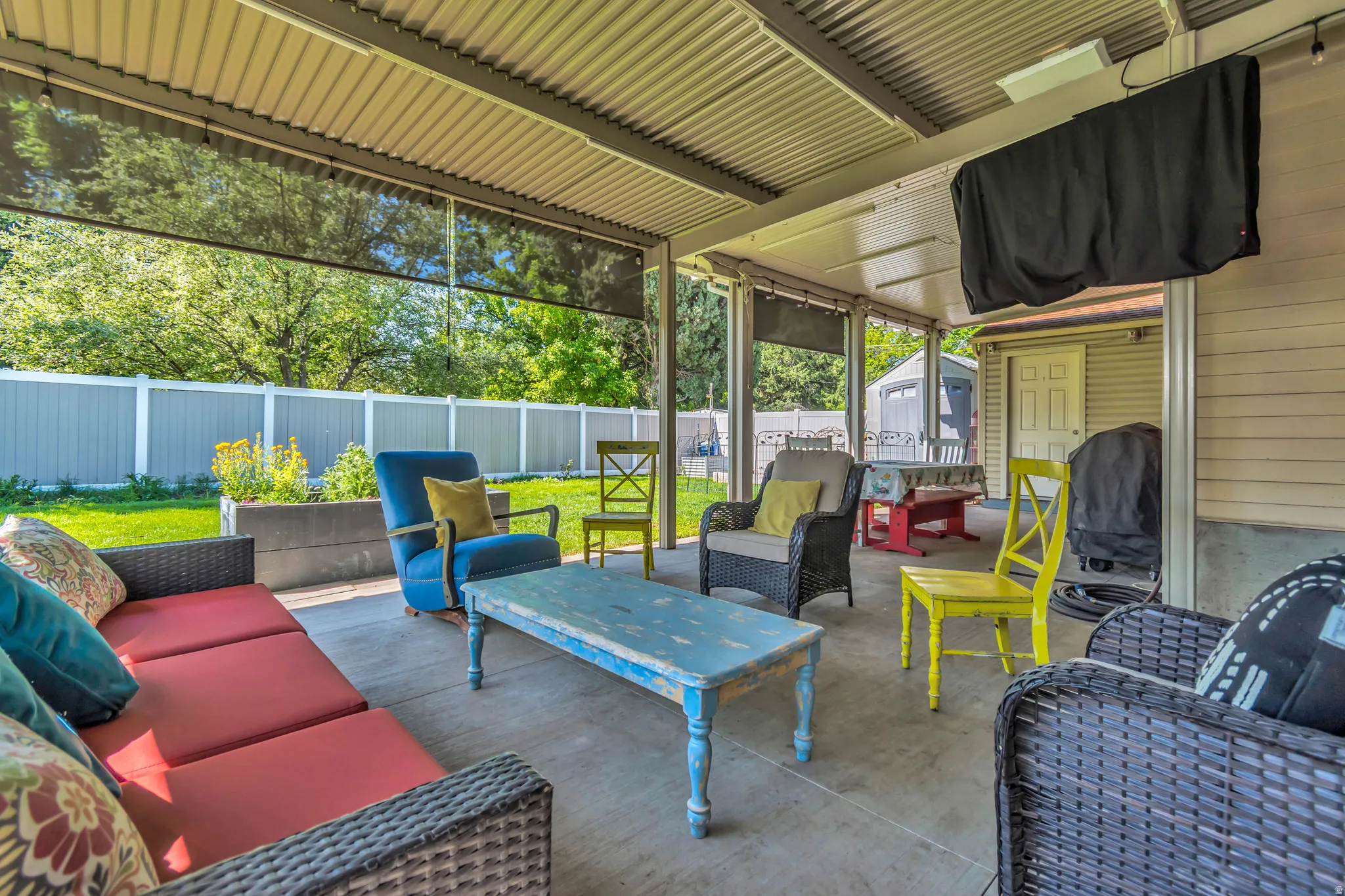 Covered patio featuring an awning that opens and closes, concrete flooring, and retractable sun shades. Great entertaining space.