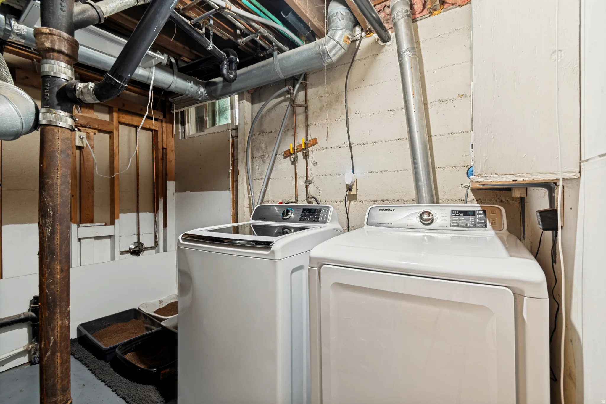 Laundry area featuring a top-load washing machine and a front-load dryer