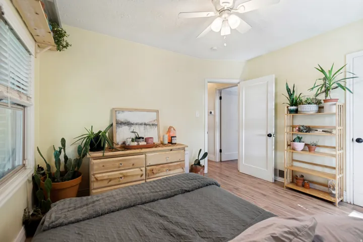 Room featuring wood flooring, light-toned walls, and a ceiling fan