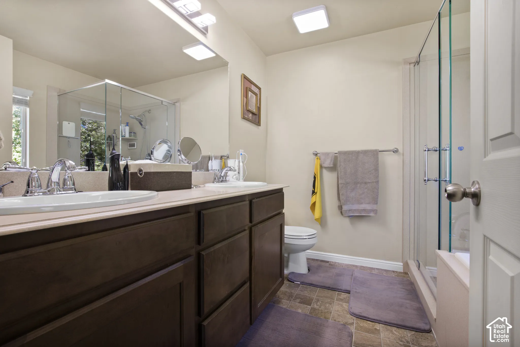 Double vanity with undermount sinks, chrome faucets, and a light-toned countertop