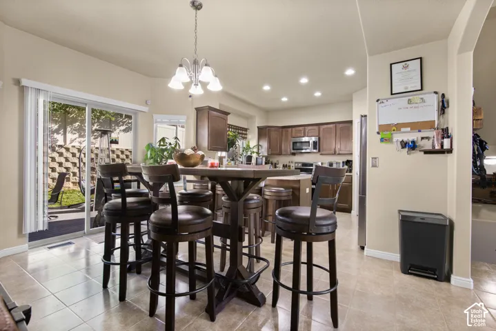 Open-concept kitchen and dining area featuring tile flooring and sliding glass door access to the backyard