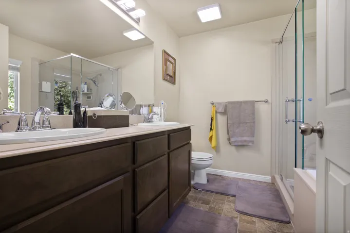 Double vanity with undermount sinks, chrome faucets, and a light-toned countertop