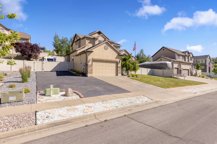Two-story stucco and stone-accented exterior with an attached two-car garage
