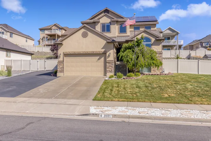 Stucco exterior with stone accents and an attached garage