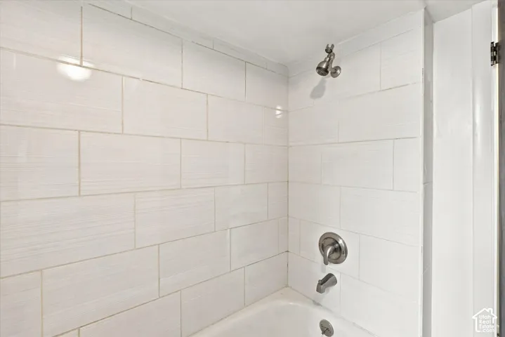 Bathtub with subway tile surround and brushed nickel fixtures