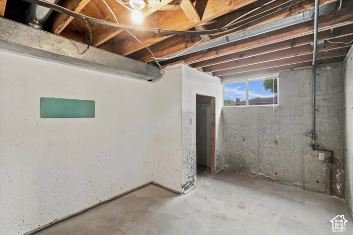 Unfinished basement room - could be another bedroom, office, or storage.