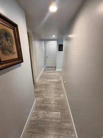 Hallway featuring wood-look tile flooring and recessed lighting