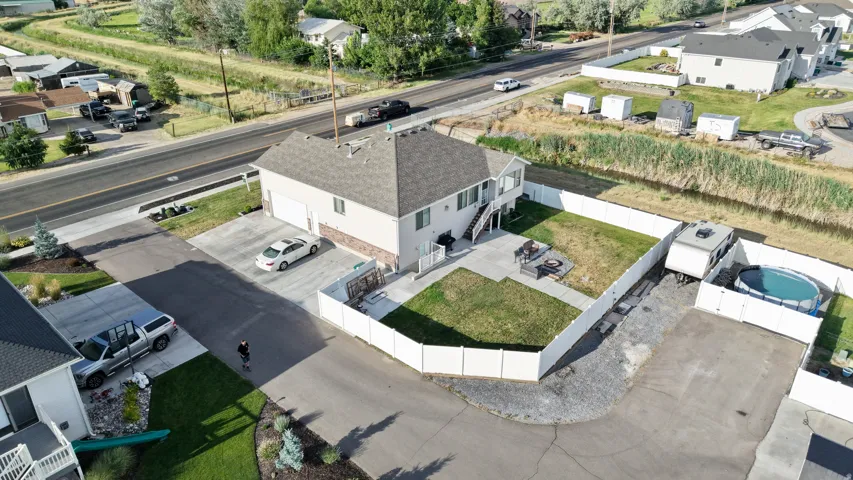Split-level residence featuring a two-car garage and a fenced backyard