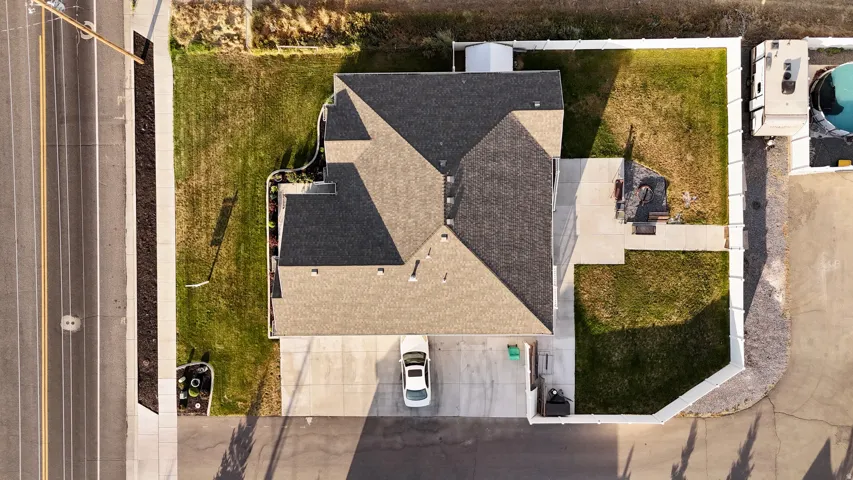 Property featuring a multi-gabled roof, concrete driveway, and attached garage