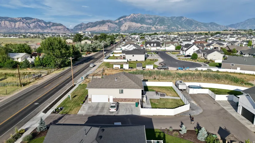 Expansive property featuring a private rear yard, attached two-car garage, and a gravel side parking area