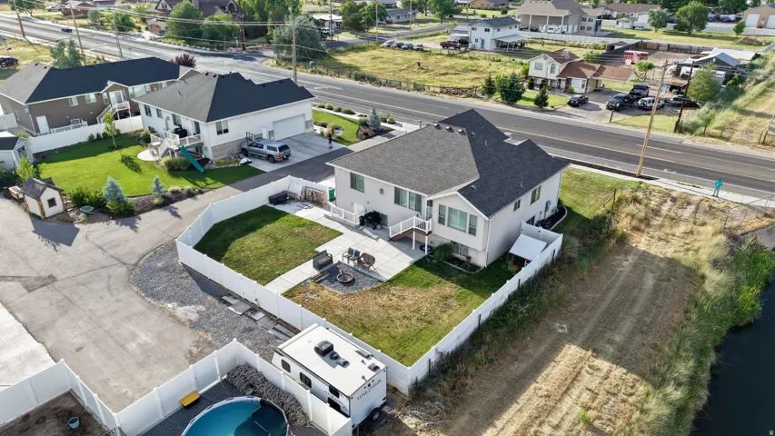 Spacious property featuring a light-colored exterior and dark-shingled roof