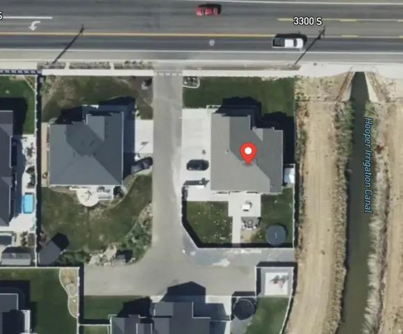 Aerial View. Depicting the property’s location relative to surrounding structures and a named canal