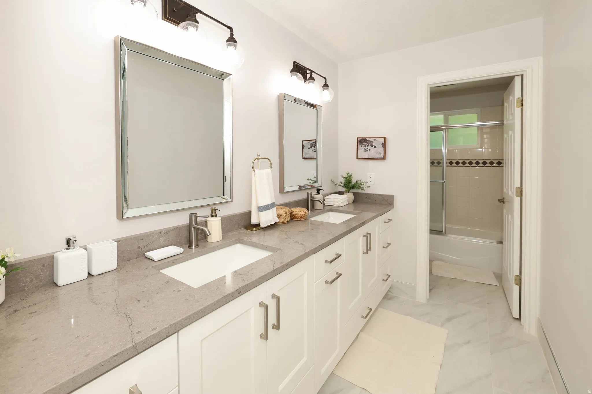 Dual vanity with light gray countertop and integrated rectangular sinks