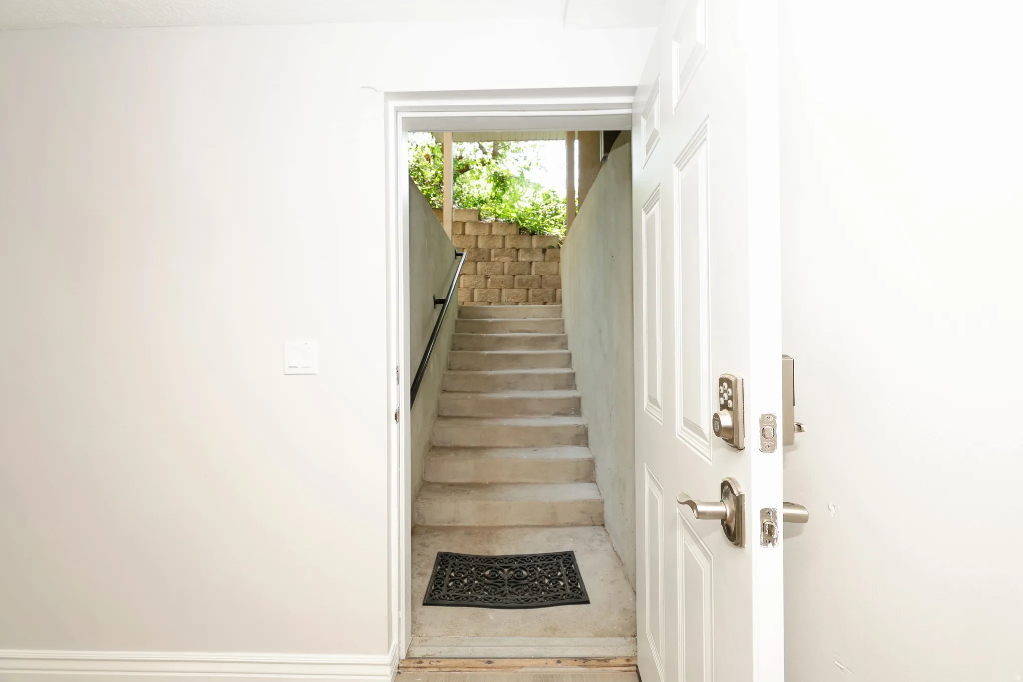 Solid core entry door with brushed nickel hardware and a keyless entry system