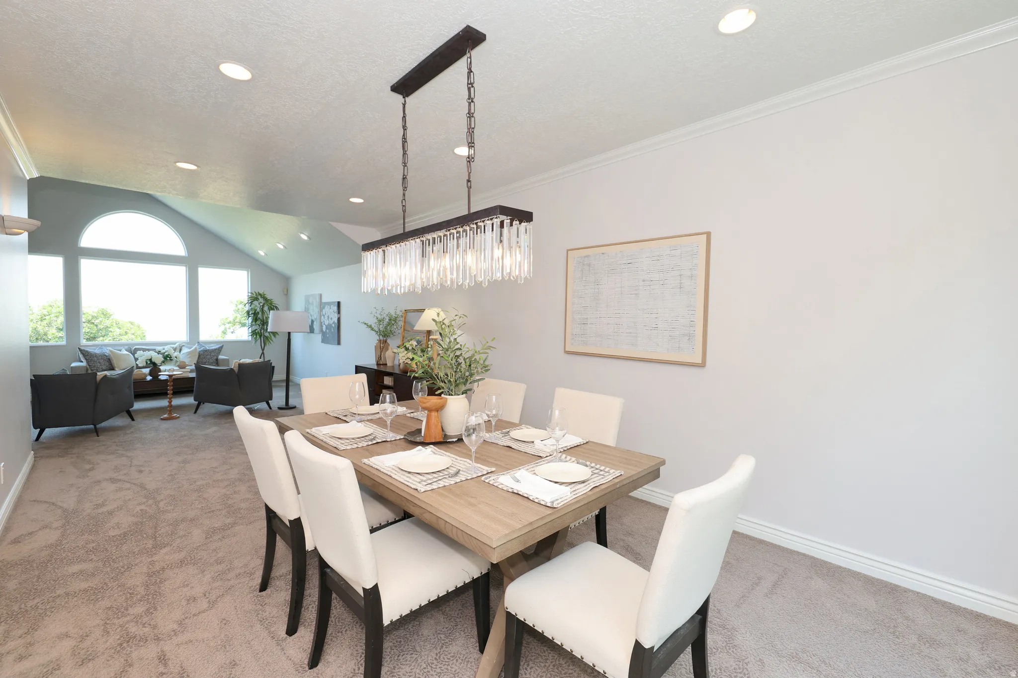 Formal dining space featuring a linear chandelier with crystal accents