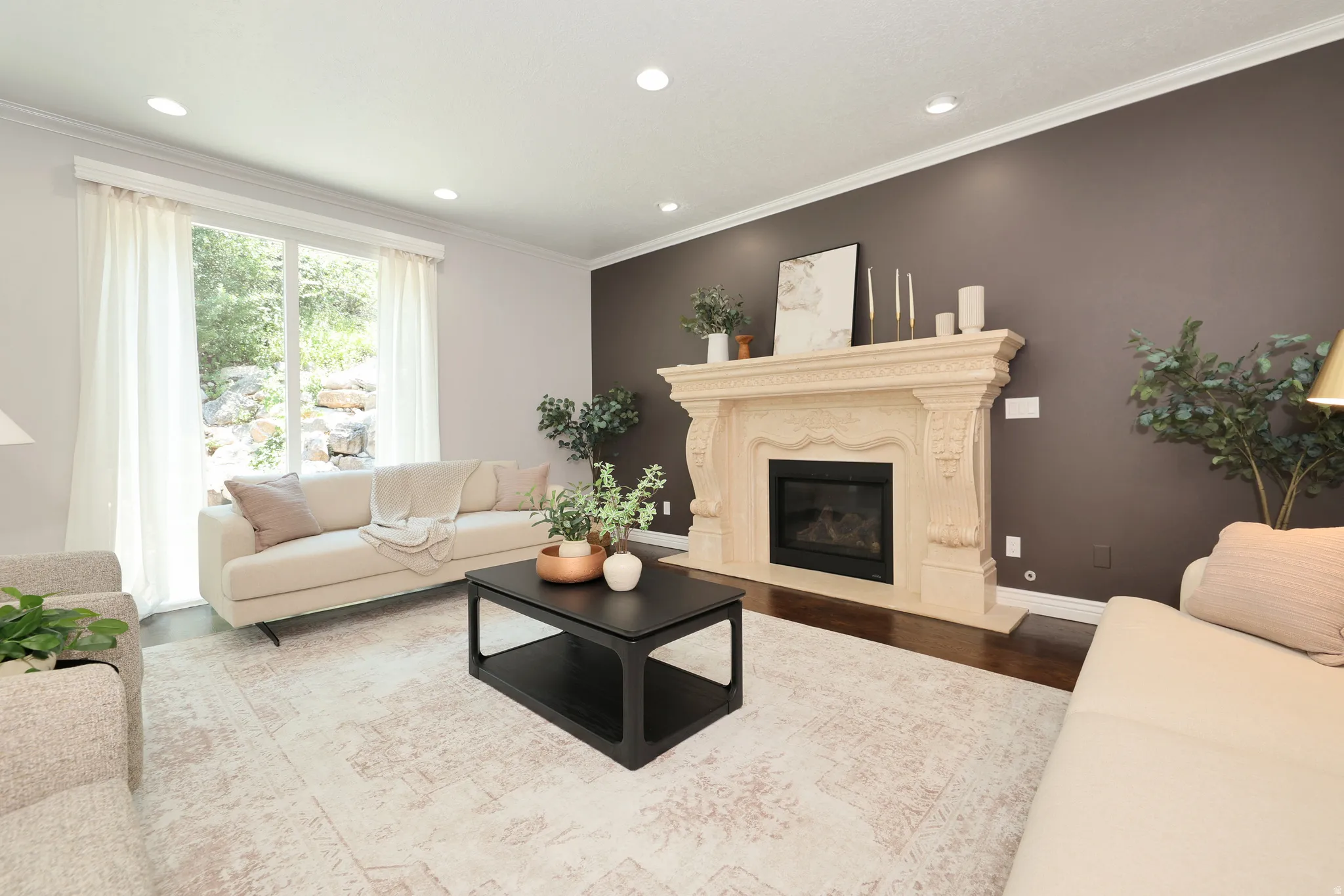 Ornate stone fireplace with a dark-tiled firebox, set against an accent wall