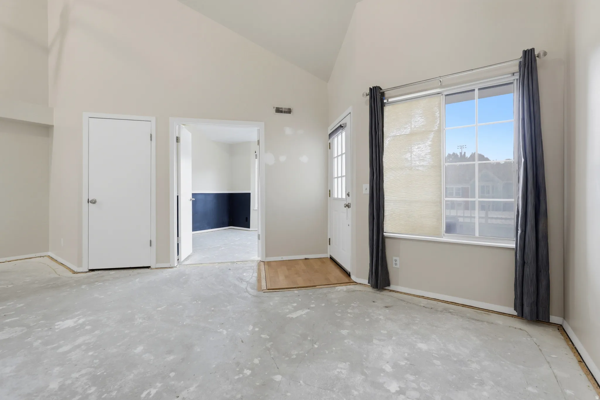 View into front bedroom and of front entry