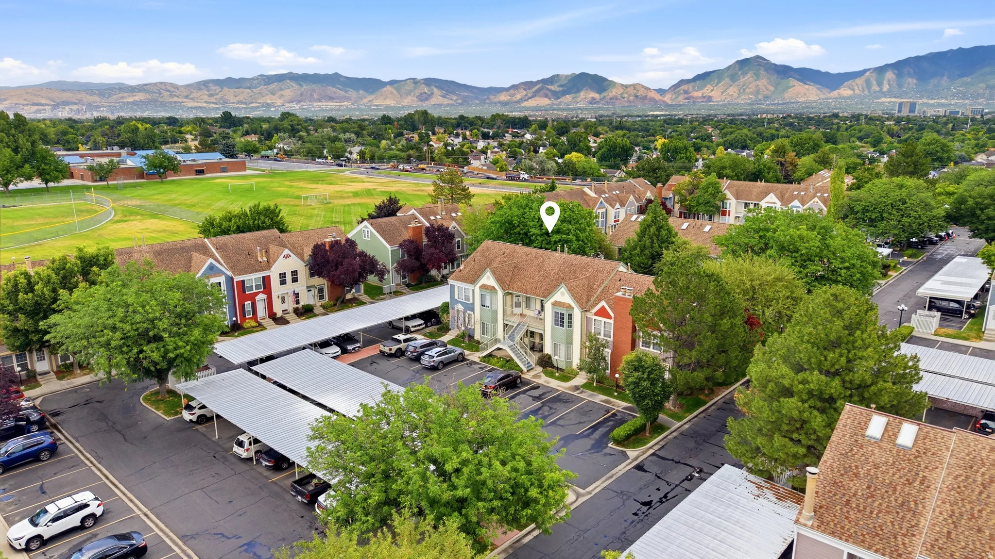 Aerial perspective showcasing a community of townhome-style residences with covered parking structures