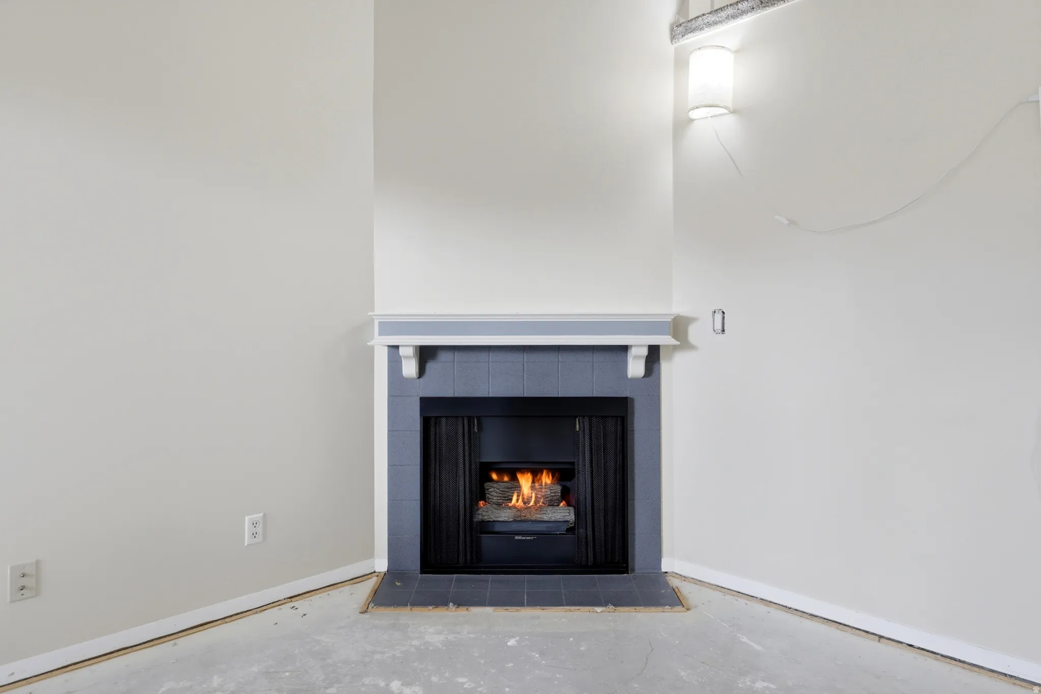 Gas Fireplace with a blue tiled surround and a white mantelpiece