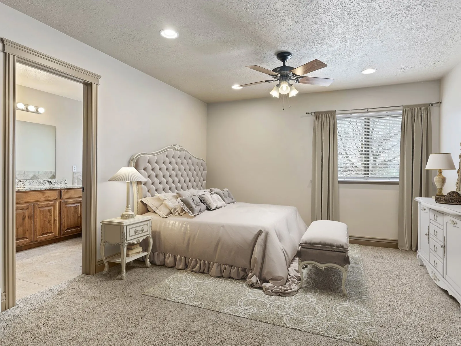 Carpeted bedroom featuring a ceiling fan with integrated lighting, a window with curtains, and recessed lighting