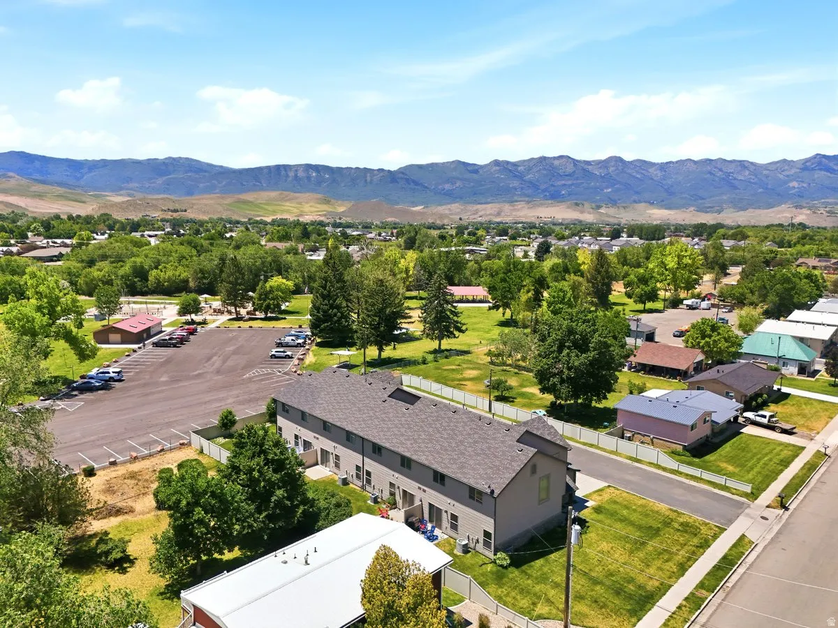 Multi-unit residential structure featuring a neutral-toned exterior and dark shingle roofing