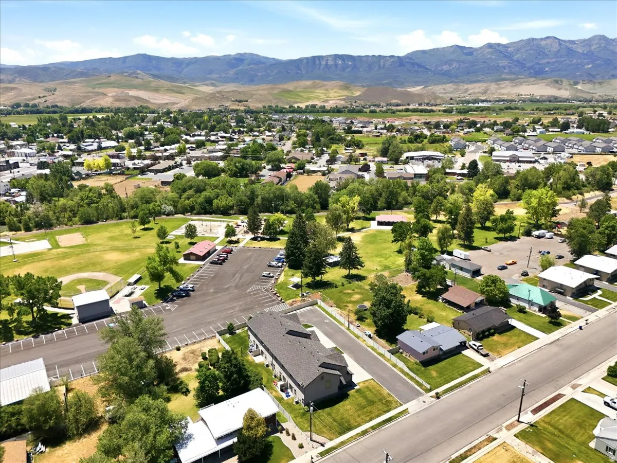 Expansive community featuring residential properties, mature trees, and a mountain backdrop