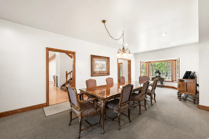 Dining area featuring a bay window, recessed lighting, and a decorative chandelier