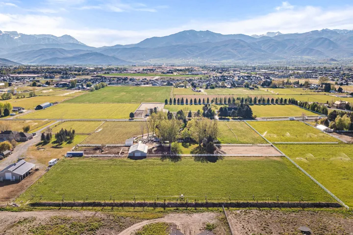 Expansive land parcels featuring established agricultural fields and mature trees