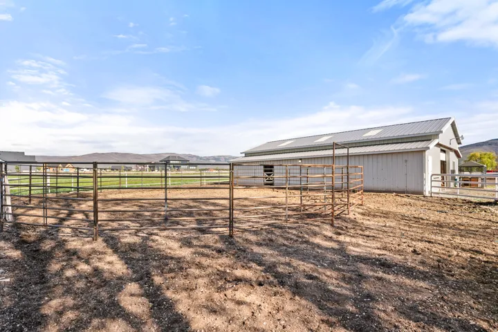 Metal-paneled barn with a corrugated metal roof and multiple skylights