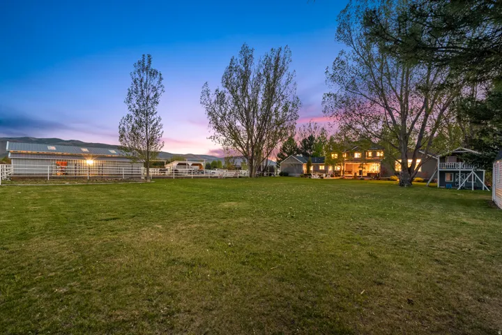 Expansive green lawn with mature trees