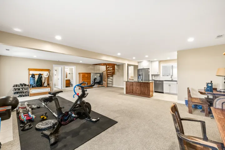 Spacious lower level featuring recessed lighting, neutral carpeting, and a spiral staircase