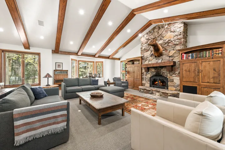 Vaulted ceilings with exposed wood beams highlight this living space