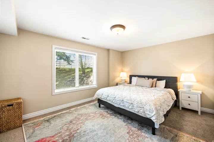 Carpeted room featuring a large window, neutral wall tones, and recessed lighting