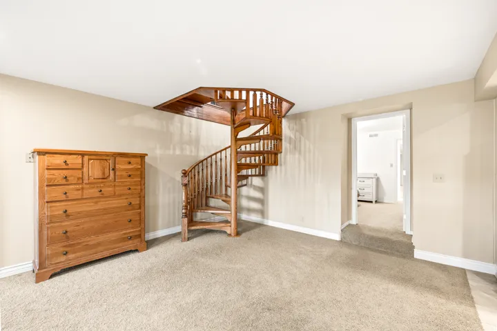 Wood spiral staircase with matching balusters and railing