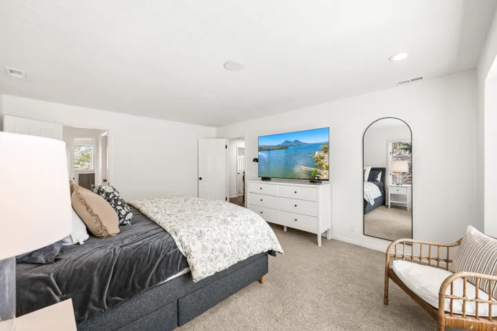 Carpeted room featuring white walls, a built-in recessed light, and a ceiling-mounted speaker