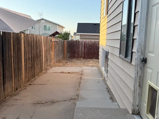 Side yard with concrete patio and wood fencing