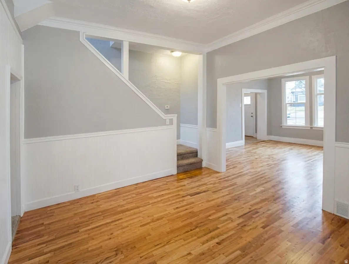 Hardwood flooring throughout the main living areas complemented by white wainscoting