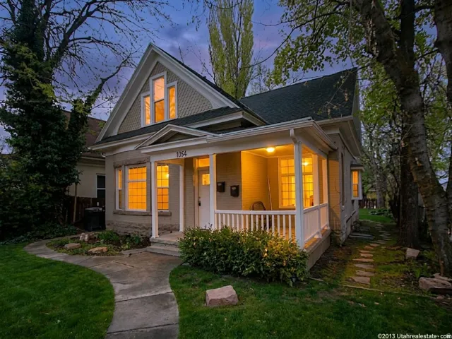 Traditional architecture with a covered front porch featuring white railings