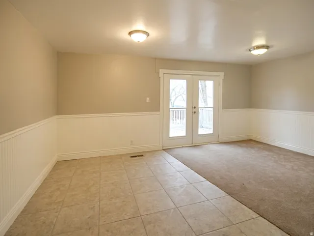 Interior room featuring neutral wall paint and white beadboard wainscoting