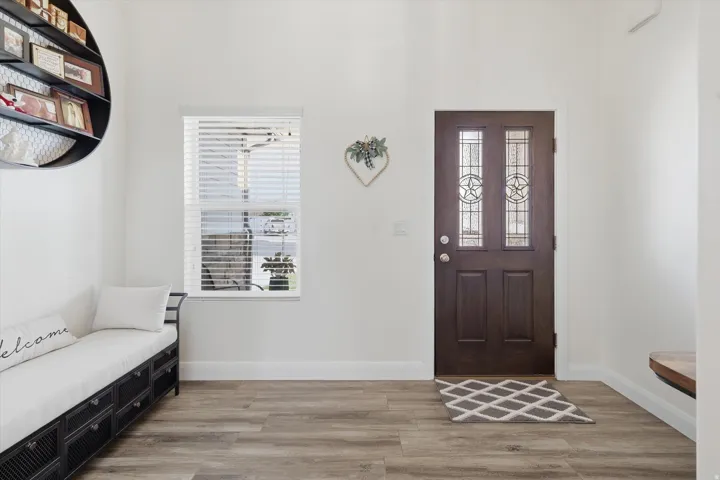 Entryway featuring a dark wood-finish door with decorative glass inserts