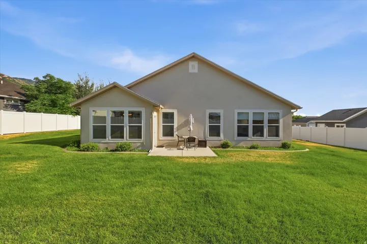 Beck of home with a concrete patio