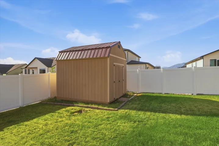 Storage shed with a gambrel-style brown metal roof