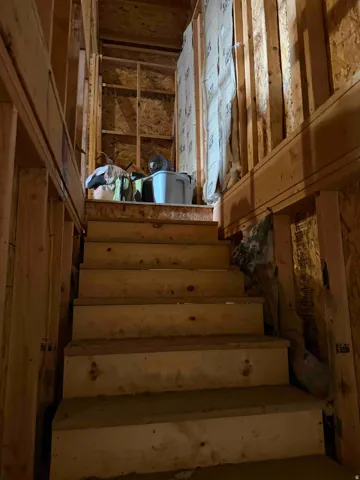 Stairs in garage leading to loft