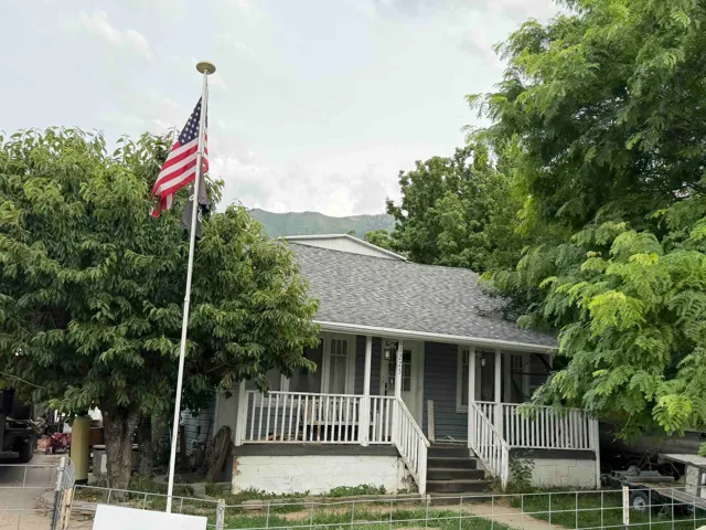 Charming single-story residence with a covered front porch featuring white railings