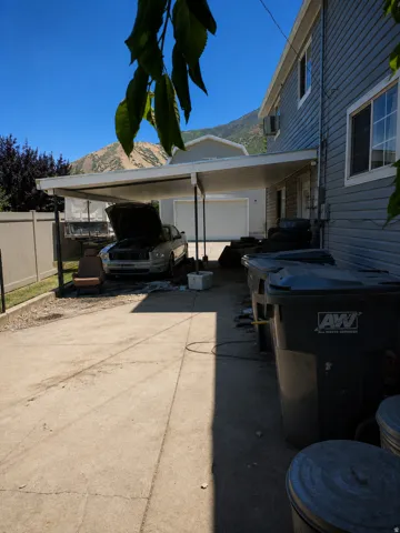 Concrete driveway providing off-street parking, carport, and mountain background