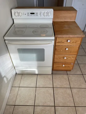 White electric range with a smooth cooktop and oven window