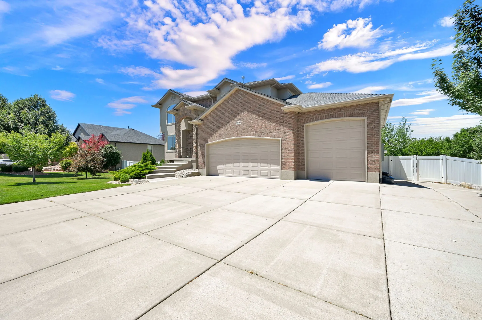 Expansive concrete driveway and two-car garage