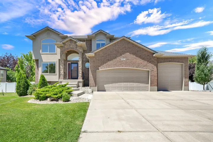 Stucco and brick exterior with stone accents and arched entry