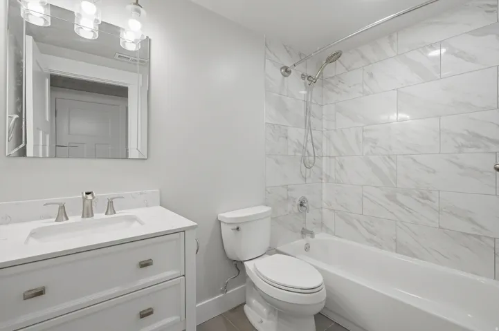 Bathroom featuring a white vanity with a rectangular sink, a white countertop, and brushed nickel fixtures